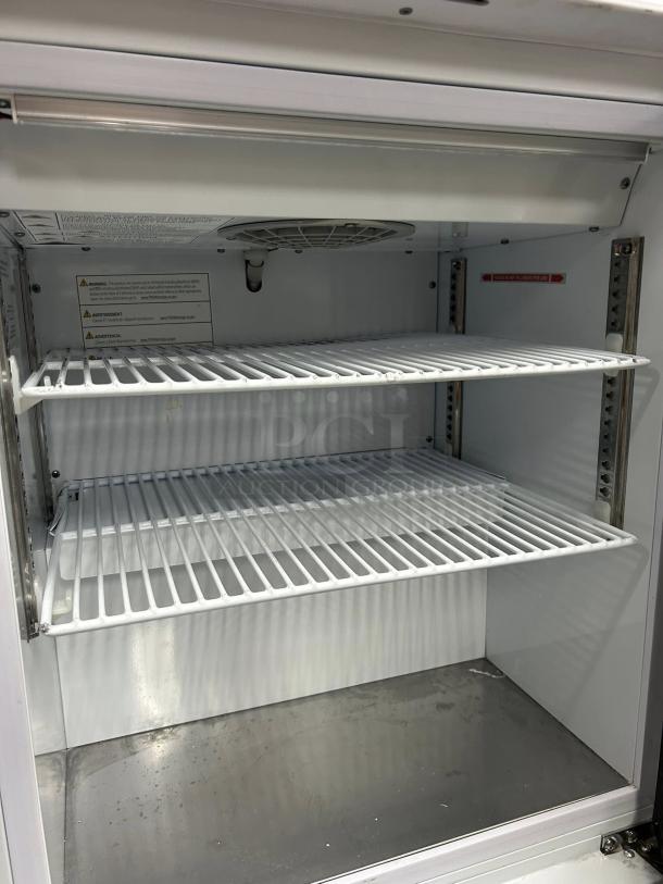 Turbo Air TSU-4RW-N6 countertop refrigerator, dual wire shelves, excellent condition, tested and working, interior view.