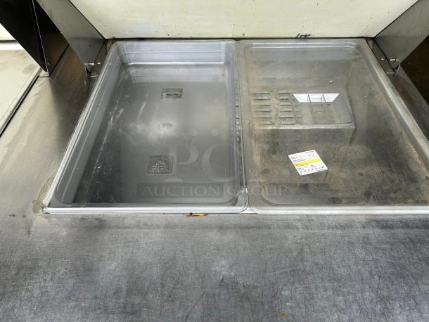 Continental SW60N24M 60" 2-door refrigerated prep table in great condition; tested and working; clear lids shown.