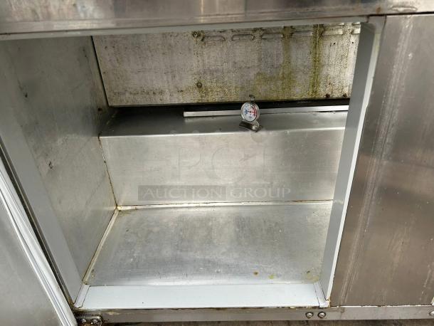 Continental SW60N24M 60" refrigerated prep table interior, showing shelves and thermometer. Good condition, tested and working.