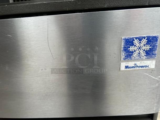 Manitowoc QD-0272A ice machine, brushed metal, visible logo. Compact, 280 lb production, 100 lb storage. Good condition.