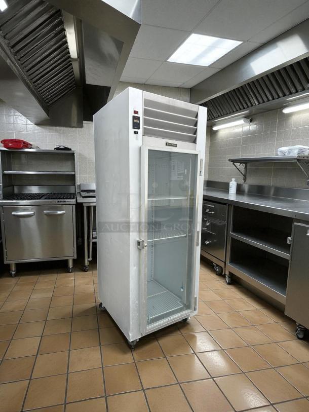 Traulsen G11010 30" G Series reach-in refrigerator with right-hinged glass door, tested and working, in commercial kitchen setting.