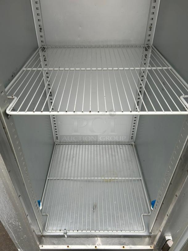 Traulsen G11010 30" G Series refrigerator interior with two wire shelves, clean condition, right-hinged glass door.