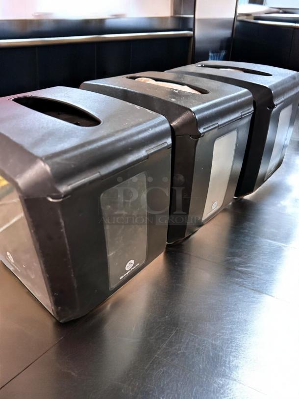 Three Dixie Ultra countertop napkin dispensers by Georgia-Pacific, black, in great condition, each 7.5" x 5.86" x 7.2".