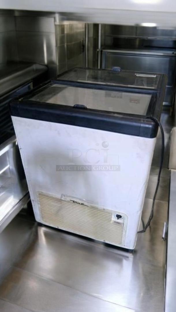 True TFM-29FL flat lid freezer, 6.3 cu. ft., excellent condition, 115V, fully tested, visible brand label on front.