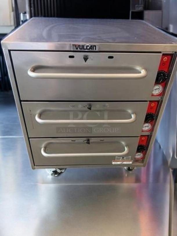Vulcan VW3S three-drawer warming cabinet, outstanding condition, stainless steel, tested, 120V, branded knobs, easy mobility.