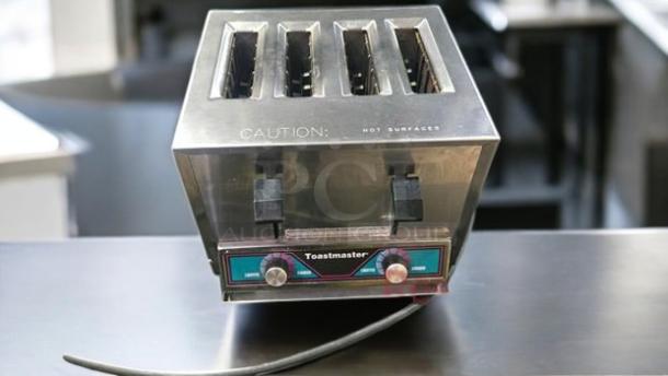 Toastmaster TP409 Commercial 4-Slot Toaster, excellent condition, 120V, Smithville, USA. Markings indicate caution for hot surfaces.