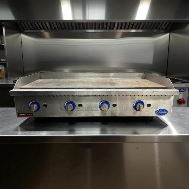 Globe GG48G 48" gas griddle with manual controls and 1" steel plate, convertible, tested and working, featuring blue knobs.