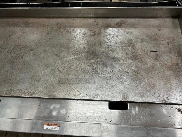 Globe GG48G 48" gas griddle, 1" steel plate, manual controls, convertible, tested working, visible wear, "Warning" label.