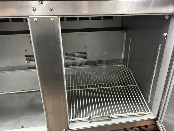 Great condition Beverage Air UCR48AHC 48" undercounter refrigerator, two sections, stainless interior, visible shelves.