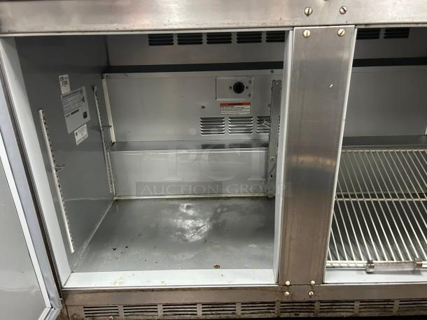 Great condition Beverage Air UCR48AHC undercounter refrigerator, 48" wide, two sections, stainless steel interior. Tags indicate model and specs.