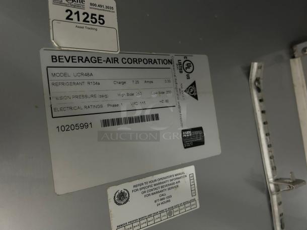 Beverage Air UCR48AHC label showing model, refrigerant, design pressure, electrical ratings. Asset tracking tag present.