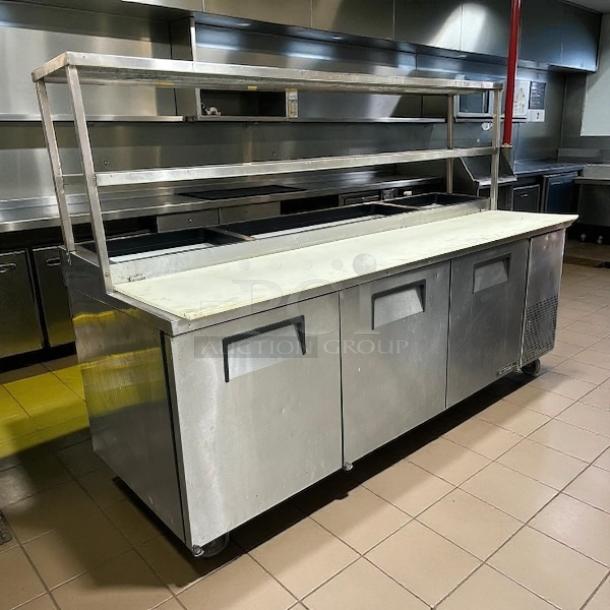 True TPP-AT2-93-HC pizza prep table, 93.5" with 3 doors and overshelf, stainless steel, tested, excellent condition.