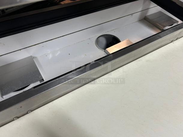 True TPP-AT2-93-HC refrigerated pizza prep table interior, stainless steel surface, clean condition, 93 1/2" wide.