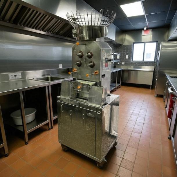 Citrocasa 8000 SB-ATS Advance Citrus Juicer in excellent condition, stainless steel, seen in a commercial kitchen.