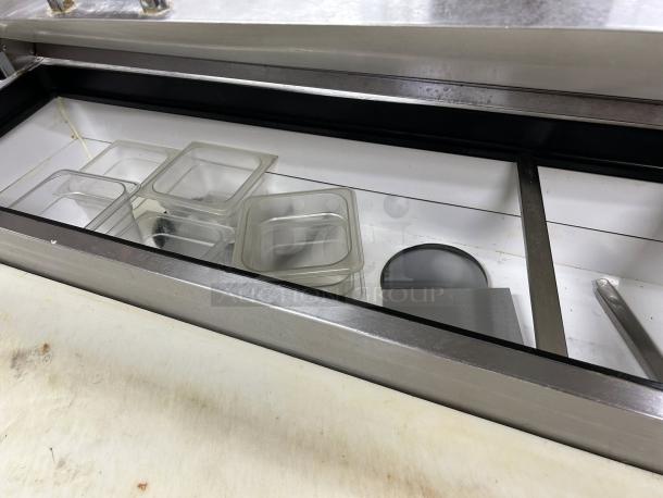 True TPP-AT-67-HC refrigerated pizza prep table with open lid, stainless steel finish, visible interior pans, tested and working.