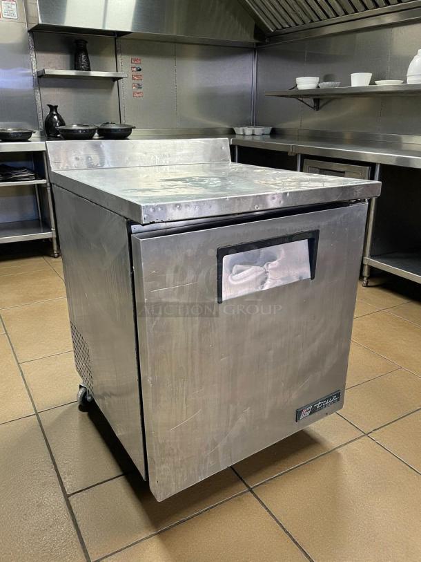 True TWT-27F-HC worktop freezer, 27 5/8", stainless steel, 3 9/16" backsplash, excellent condition, tested, with True logo.