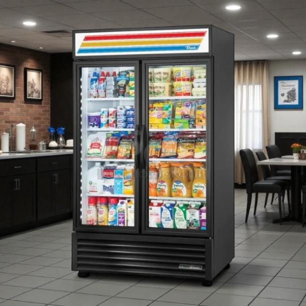 True GDM-43-HC~TSL01 black glass door merchandiser, 47 1/8", excellent condition, tested and working, colorful top signage.
