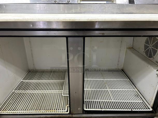 True TPP-AT-67-HC 67" Refrigerated Pizza Prep Table, 2-door, tested and working, with metal shelves, visible fan, interior wear.