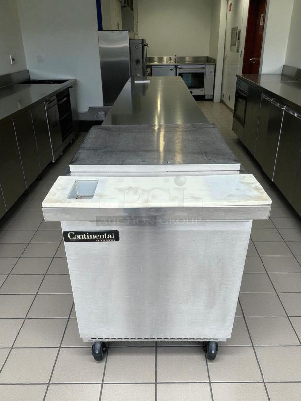 Continental Refrigerator SW27-N-12M sandwich prep table, 27", stainless steel, great condition, on wheels.