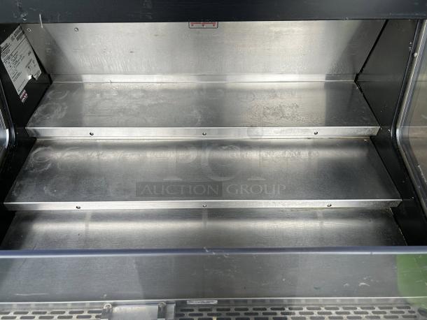 True THAC-36-HC-LD open air curtain merchandiser. Stainless steel interior, 36" wide, tested and working, minor wear visible.