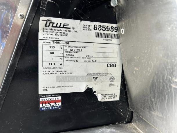 Label on True THAC-36-HC-LD refrigerated merchandiser, detailing specs like 115V, R134A refrigerant, Made in USA.