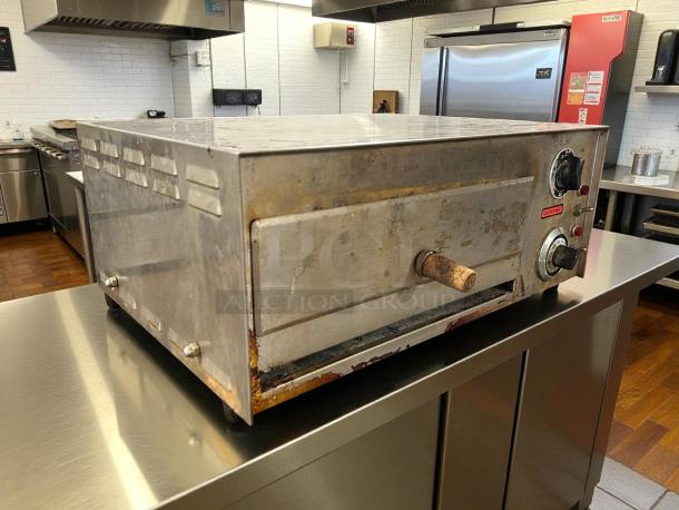Nemco 6210 countertop pizza oven, tested and working, rust on handle, visible control knobs and caution label.