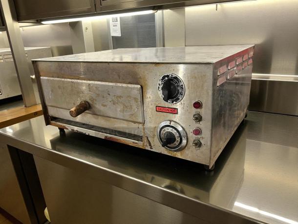Nemco 6210 countertop oven, tested and working. Features dials, caution label, used condition, ideal for pizza.