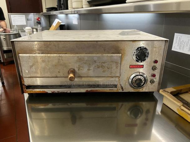 Nemco 6210 countertop pizza oven, stainless steel, visible wear, tested and working, "Caution Hot" label.