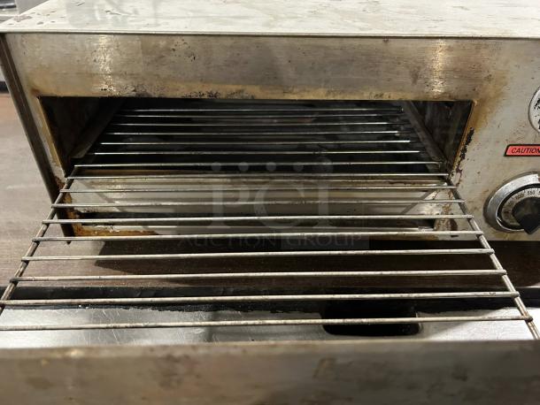 Nemco 6210 countertop oven, stainless steel, tested and working, visible dial, and wire rack inside. Signs of wear.