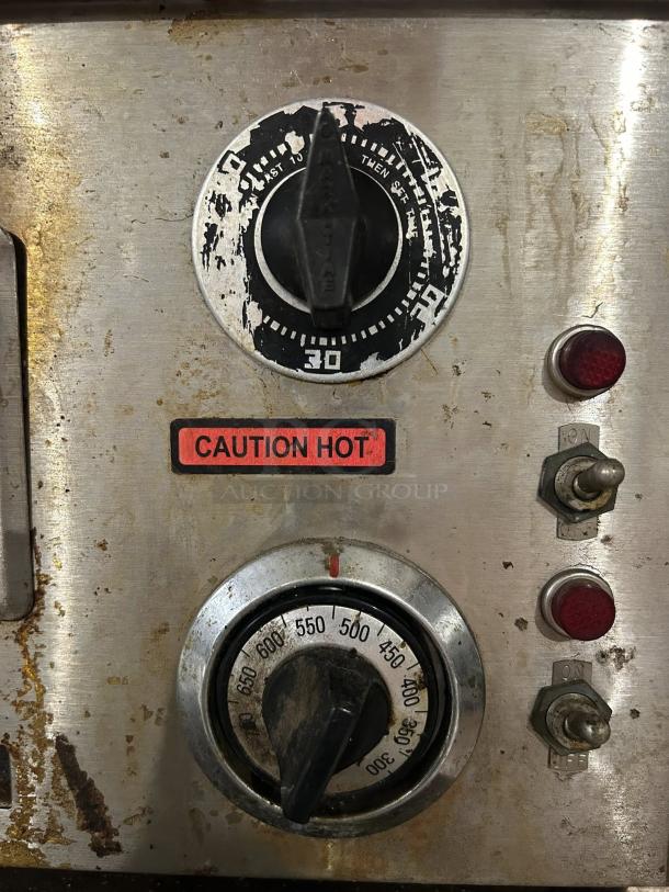 Nemco 6210 countertop oven controls with dial, caution label, wear and rust visible, indicating tested working condition.