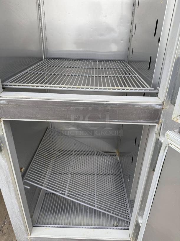 True STG1R-2HS-HC refrigerator, 27.5", dual solid doors, right hinge. Interior shelves shown, tested and working condition.
