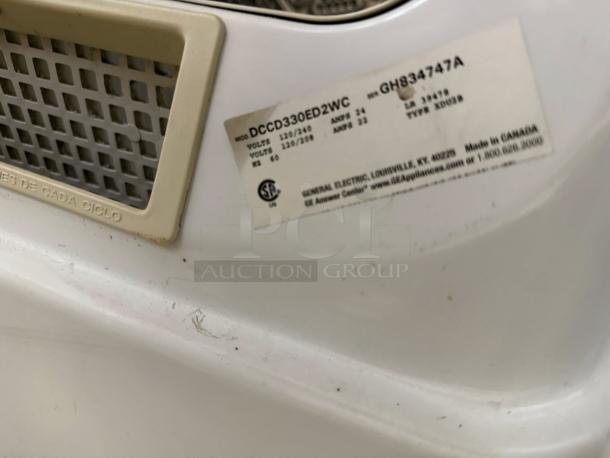 GE Model DCCD330EDWC 7.0 Cu. Ft. Coin-Operated Dryer, in excellent condition, tested and working. Tags show specs.