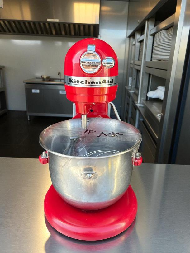 Red KitchenAid Professional 6000HD Artisan Series tilt-head stand mixer, tested and working, with stainless steel bowl.