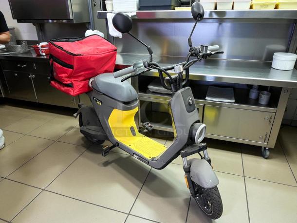 Segway eMoped C80 scooter, like new, gray and yellow, with rear storage box. Features sleek design and handlebars.