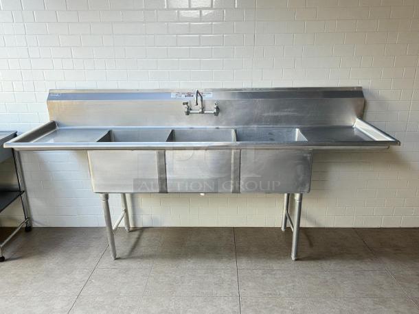 All Strong 90” 3 compartment stainless steel sink, each 18”x18”, in great condition, visible labels, backsplash faucet.
