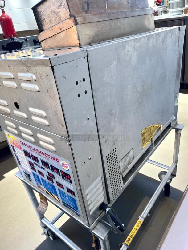 Duke FBB-NC-120 gas conveyor toaster oven, 43"W x 30"D x 53"H, natural gas, 120V. Excellent condition, visible controls and troubleshooting guide.