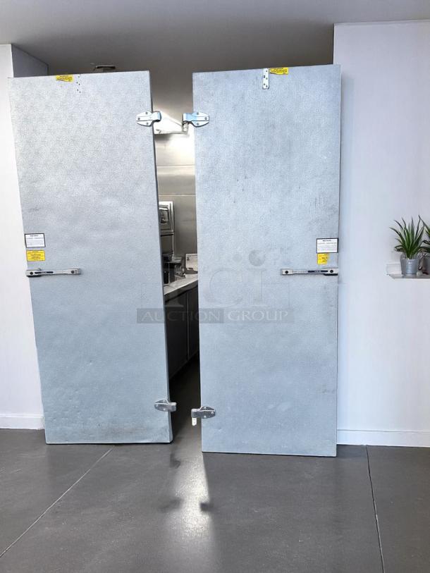 Norlake walk-in cooler with double doors, heavy-duty insulated panels, visible safety labels, fully tested and working.