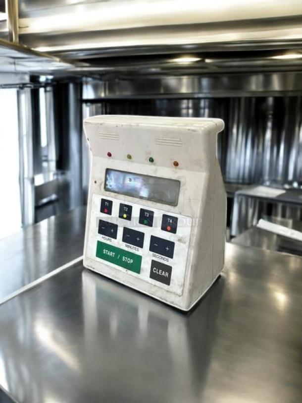 FMP 141-7501 commercial digital 4-channel timer, excellent condition, tested and working, on stainless steel surface.