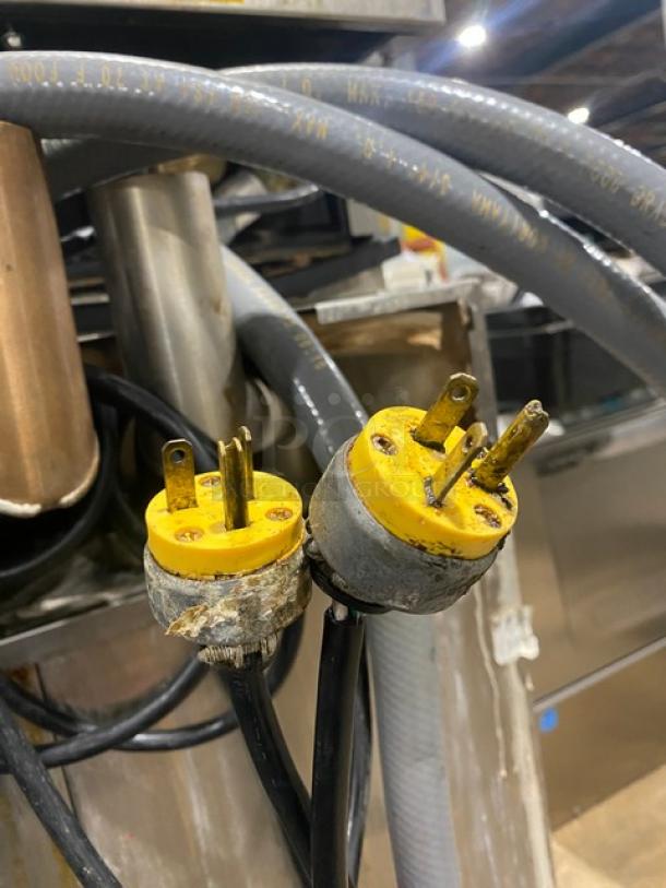 Close-up of yellow electrical plugs on Rational iCombi Pro Series Combi Oven, Model LM100CGAXXXX, showing wear.