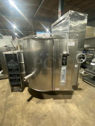 Commercial stainless steel tilting steam kettle with swing spout faucet, natural gas powered, on legs, excellent condition.