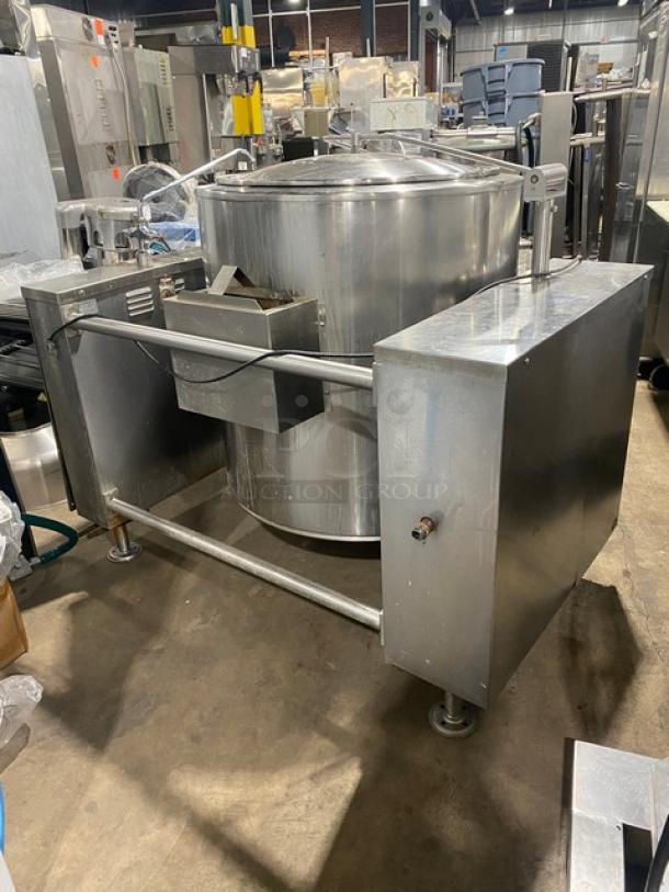 Commercial stainless steel natural gas tilting steam kettle with swing spout faucet, on legs, in good condition.