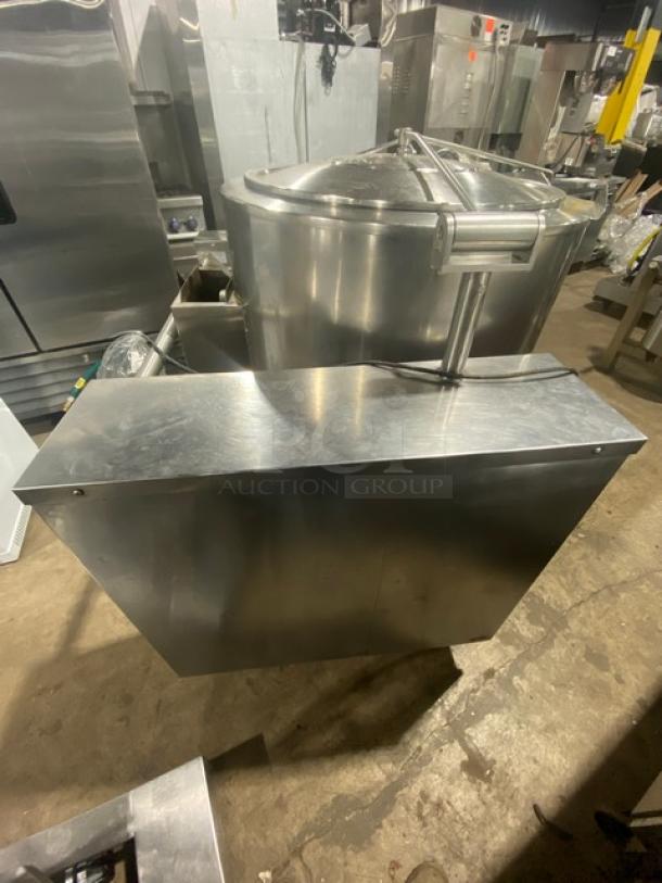 Commercial stainless steel tilting steam kettle, natural gas powered, with swing spout faucet and sturdy legs. Excellent condition.