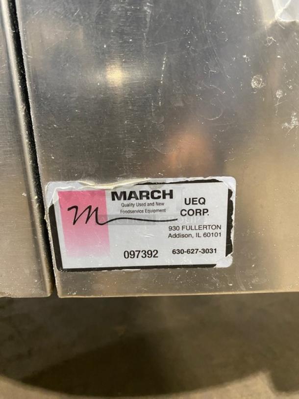 Commercial stainless steel tilting steam kettle with swing spout faucet. Gas powered, on legs. March UEQ Corp label shows location and contact.