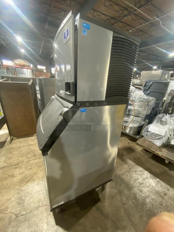 Manitowoc Indigo Series IYT0500A-161 ice machine, stainless steel, air-cooled, Energy Star certified, on legs, with ice scooper.