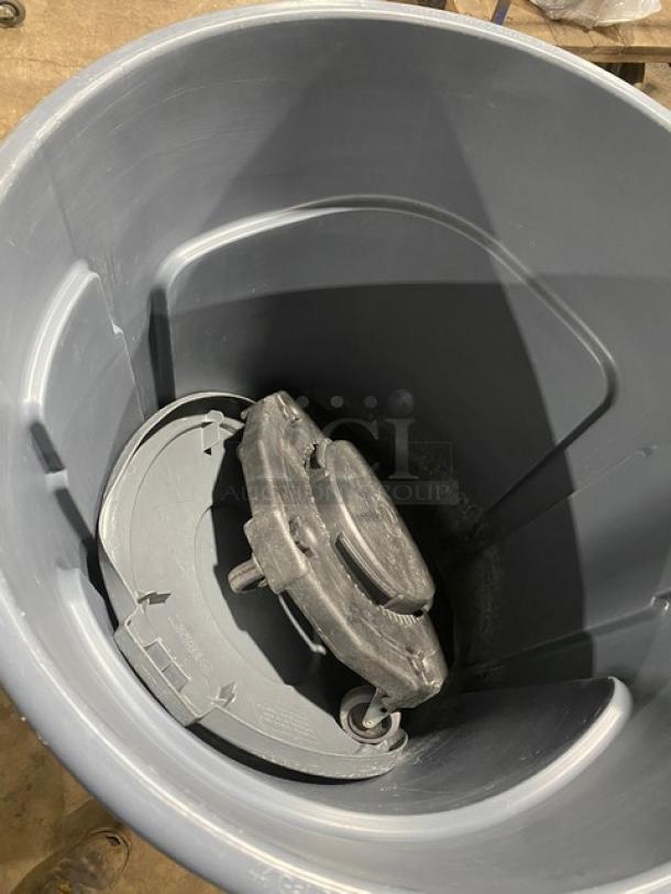 Rubbermaid BRUTE 44 Gal. gray trash container with dolly, shown inside. Made for commercial use. In good condition.