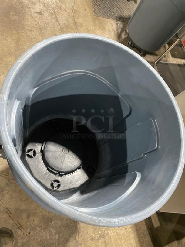 Rubbermaid BRUTE Series 44 Gal. gray trash container with dolly, commercial grade, excellent condition, interior view.