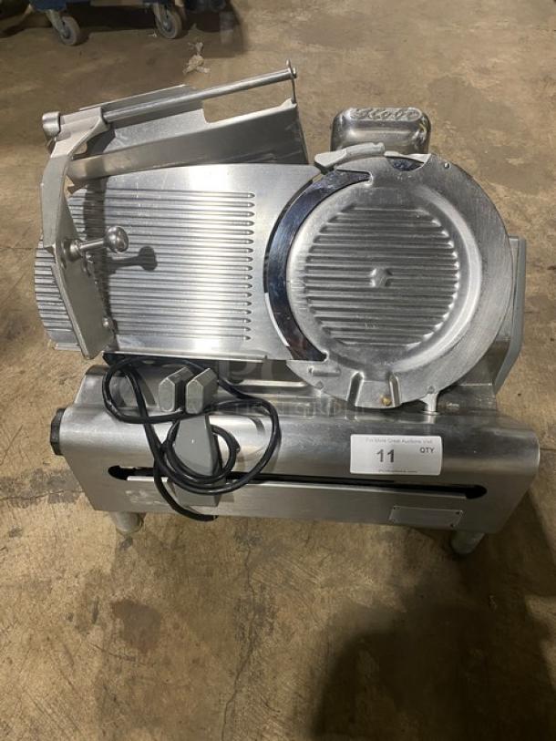Globe commercial electric deli meat slicer on legs, heavy-duty, silver finish, shows wear, power cord attached. Tag indicates auction lot 11.