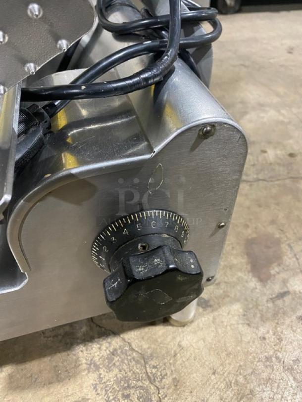 Globe commercial electric deli meat slicer, heavy-duty, on legs. Features adjustable thickness dial, used condition.