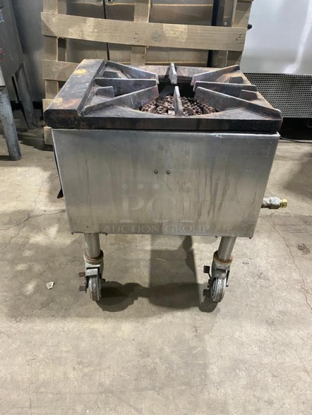 Commercial stainless steel natural gas single burner stock pot range on casters. Used condition with surface wear.