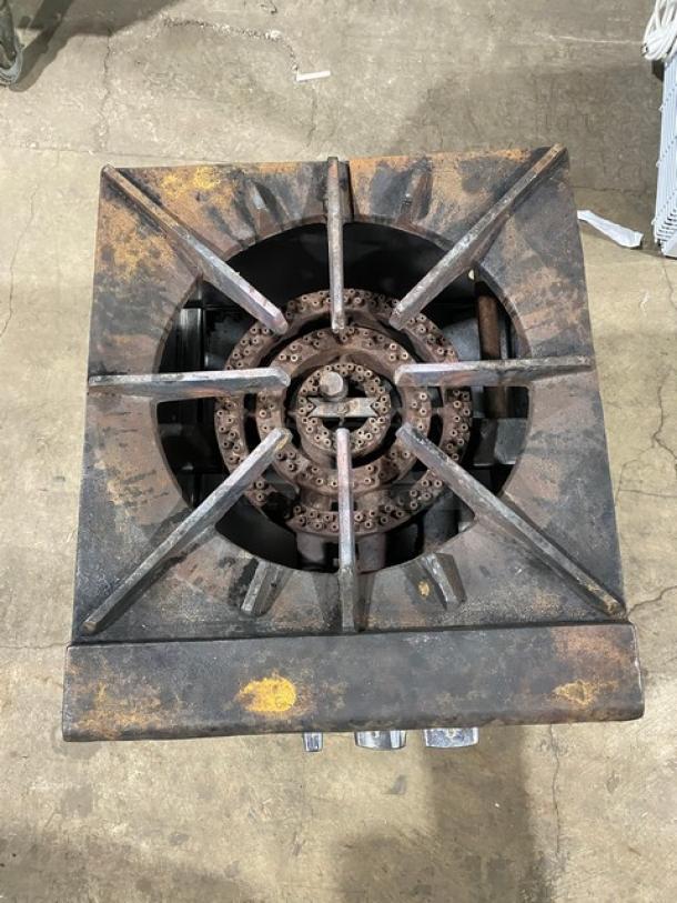 Commercial stainless steel single burner stock pot range on casters, natural gas powered, visible wear, industrial use.